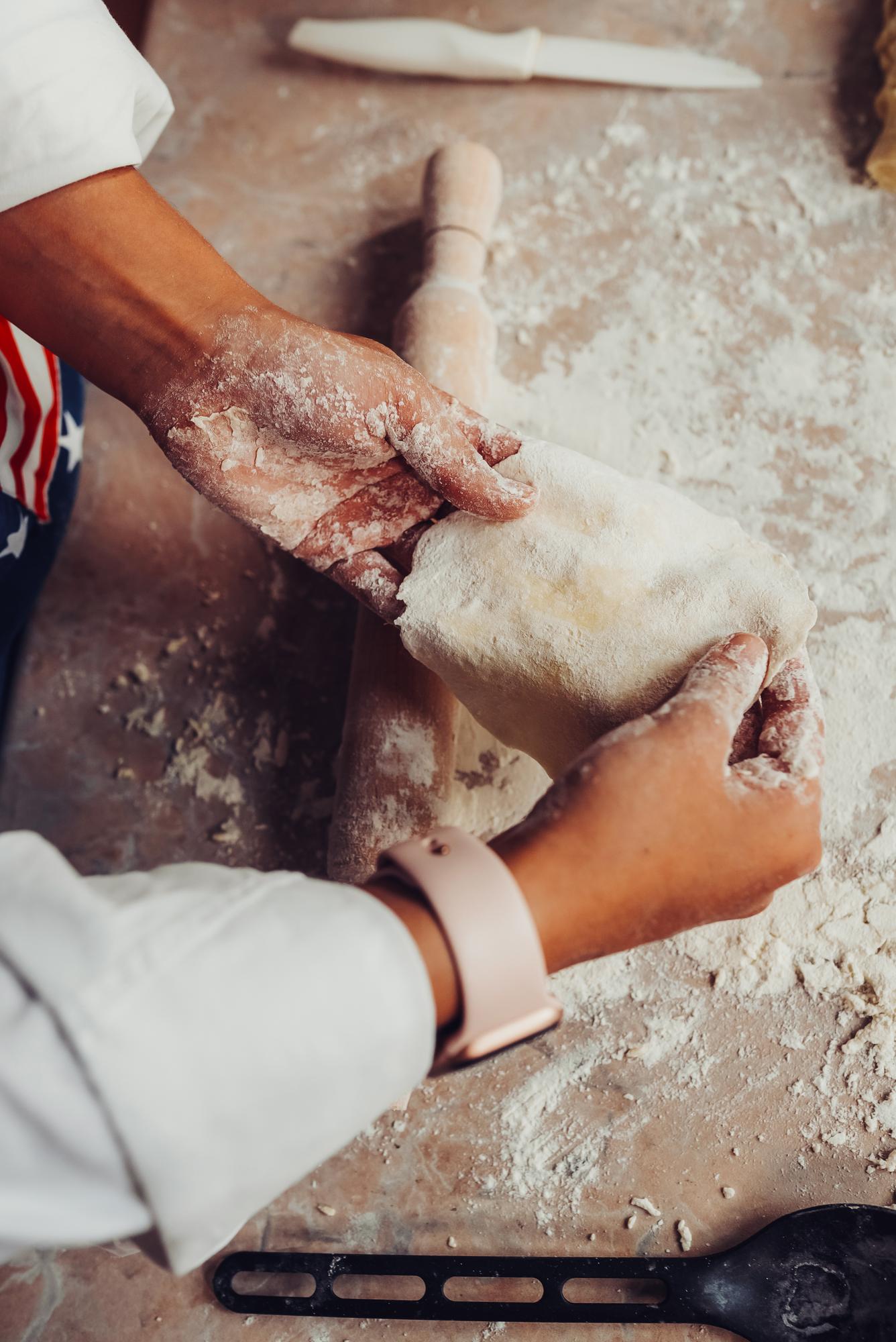 close-up of hands kneading dough
